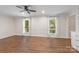 Bright and airy living room showcasing wood-look floors and large windows with charming sheer curtains at 3101 Willowbrae Rd, Charlotte, NC 28226
