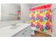 Bathroom featuring single vanity, toilet, and a shower/tub with colorful curtain at 3201 Heathstead Pl # C, Charlotte, NC 28210