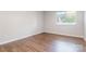 Bedroom with hardwood floors, baseboard trim, window overlooking trees, and electrical outlets at 3201 Heathstead Pl # C, Charlotte, NC 28210