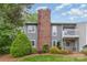 Well-maintained gray two-story home features a brick chimney and an inviting second story balcony at 3201 Heathstead Pl # C, Charlotte, NC 28210