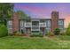 Charming condominium exterior featuring a well-maintained lawn, beautiful landscaping, and brick chimney perfect for relaxing and outdoor enjoyment at 3201 Heathstead Pl # C, Charlotte, NC 28210