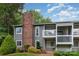 Condominium exterior featuring a well-maintained yard, manicured bushes, and inviting balcony ideal for relaxation and outdoor enjoyment at 3201 Heathstead Pl # C, Charlotte, NC 28210