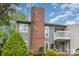 Well-maintained gray two-story home features a brick chimney and an inviting second story balcony at 3201 Heathstead Pl # C, Charlotte, NC 28210
