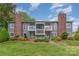 An attractive condo exterior with manicured front lawn and brick chimney stacks on either end at 3201 Heathstead Pl # C, Charlotte, NC 28210