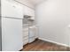 A kitchen featuring white cabinets, stove, and refrigerator with hardwood floors at 3201 Heathstead Pl # C, Charlotte, NC 28210