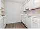 A kitchen featuring white cabinets, stove, refrigerator and dishwasher with hardwood floors at 3201 Heathstead Pl # C, Charlotte, NC 28210