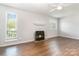 Inviting living room featuring hardwood floors, a decorative fireplace, and large windows that provides a warm and inviting space at 3201 Heathstead Pl # C, Charlotte, NC 28210