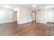 Spacious living room featuring hardwood floors, a closet, access to the kitchen, and providing ample space for relaxation at 3201 Heathstead Pl # C, Charlotte, NC 28210