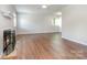 Bright living room featuring hardwood floors, a fireplace, and plenty of natural light, perfect for creating a cozy and inviting atmosphere at 3201 Heathstead Pl # C, Charlotte, NC 28210
