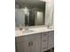 Bathroom boasts double sinks with white countertops and cabinets, and a glass enclosed shower at 345 Hyssop Ct, Fort Mill, SC 29715