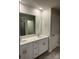 Bright bathroom featuring double vanity, large mirror, and shower with glass door at 345 Hyssop Ct, Fort Mill, SC 29715
