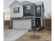 Two-story home with gray and white siding, stone accents, and a two-car garage at 345 Hyssop Ct, Fort Mill, SC 29715