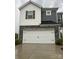 Front exterior of a two-story home with a white garage door and stone accents at 345 Hyssop Ct, Fort Mill, SC 29715