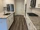 Modern kitchen with stainless appliances, white cabinets, and granite countertops at 345 Hyssop Ct, Fort Mill, SC 29715