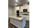 Well-lit kitchen features a granite island, stainless steel appliances, and white cabinetry at 345 Hyssop Ct, Fort Mill, SC 29715