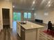 Open kitchen with granite island, stainless appliances, and view of the living area at 345 Hyssop Ct, Fort Mill, SC 29715
