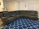 Spacious living room featuring gray sectional sofa and patterned blue area rug at 345 Hyssop Ct, Fort Mill, SC 29715