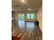 Bright, open living room with wood floors and natural light from sliding glass door at 345 Hyssop Ct, Fort Mill, SC 29715