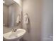 A clean half-bath features a pedestal sink, octagon mirror, and wall-mounted towel bar at 417 Homestead Ln, Albemarle, NC 28001