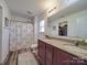 Bathroom featuring a double vanity, modern fixtures, and shower with patterned curtain, offering style and comfort at 417 Homestead Ln, Albemarle, NC 28001