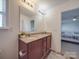 Bathroom featuring a double sink vanity, granite countertop, large mirror, and stylish decor elements at 417 Homestead Ln, Albemarle, NC 28001