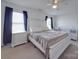 Bright bedroom featuring a decorative bed frame, ceiling fan, and large windows providing natural light at 417 Homestead Ln, Albemarle, NC 28001