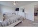 Bedroom featuring a ceiling fan, carpeted floor, and a dresser with a mirror for added functionality at 417 Homestead Ln, Albemarle, NC 28001