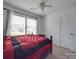 Bedroom featuring a ceiling fan, carpeted floor, and a large window providing plenty of natural light at 417 Homestead Ln, Albemarle, NC 28001