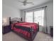 Cozy bedroom featuring a dark bed frame, ceiling fan, and carpeted floor at 417 Homestead Ln, Albemarle, NC 28001