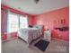 Stylish bedroom featuring light colored walls, carpeted floor, and a large window providing plenty of natural light at 417 Homestead Ln, Albemarle, NC 28001