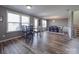 Bright dining area features wood floors, large windows with blinds, and two dining tables at 417 Homestead Ln, Albemarle, NC 28001