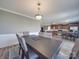 Elegant dining room with a large wooden table and seating for six, adjacent to a modern kitchen at 417 Homestead Ln, Albemarle, NC 28001