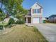 Attractive two-story house featuring a well-kept lawn, attached garage, and charming front porch at 417 Homestead Ln, Albemarle, NC 28001