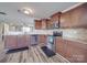Modern kitchen with stainless steel appliances, granite countertops, and dark wood cabinets at 417 Homestead Ln, Albemarle, NC 28001