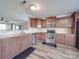 Well-appointed kitchen with stainless steel appliances, tile backsplash, and ample cabinet space at 417 Homestead Ln, Albemarle, NC 28001
