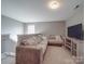 Cozy living area features a large sectional sofa, media center, and neutral carpet at 417 Homestead Ln, Albemarle, NC 28001