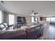 Spacious living room featuring a large, comfortable leather sofa, ceiling fan, and hardwood flooring at 417 Homestead Ln, Albemarle, NC 28001