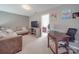 Comfortable living space includes a brown sectional sofa, desk, and adjacent bedroom view at 417 Homestead Ln, Albemarle, NC 28001