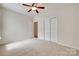 Bedroom with ceiling fan, carpet, and closet; neutral tones offer a cozy space at 422 Garnet Ct, Fort Mill, SC 29708