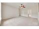 Open bedroom showcasing an attached bathroom, ceiling fan, and neutral decor at 422 Garnet Ct, Fort Mill, SC 29708