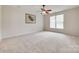 Spacious bedroom with large window, ceiling fan and modern decor for comfort at 422 Garnet Ct, Fort Mill, SC 29708
