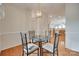 Well-lit dining area next to kitchen features hardwood floors, stylish lighting, and space for entertaining guests at 422 Garnet Ct, Fort Mill, SC 29708
