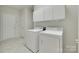Bright laundry room with washer, dryer, and white cabinetry at 422 Garnet Ct, Fort Mill, SC 29708