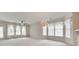 Spacious living room featuring large windows, chandelier, and ceiling fan providing a welcoming atmosphere at 422 Garnet Ct, Fort Mill, SC 29708