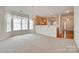 Open living room showcasing kitchen with wood cabinets, large windows, and chandelier for a bright space at 422 Garnet Ct, Fort Mill, SC 29708