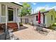 A brick patio features black metal furniture, a metal fence, and easy access to the house and detached garage at 4960 York Hwy, Rock Hill, SC 29732