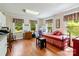The bonus room features hardwood floors, a day bed, and three windows bringing in natural light at 4960 York Hwy, Rock Hill, SC 29732
