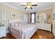 A nicely decorated bedroom features a ceiling fan, hardwood floors, and a large white dresser with framed art at 4960 York Hwy, Rock Hill, SC 29732