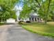 This single Gathering house has a covered front porch with stone pillars, a large driveway, and detached garage at 4960 York Hwy, Rock Hill, SC 29732