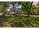 Charming home featuring a large front yard and a welcoming front porch with stone pillars at 4960 York Hwy, Rock Hill, SC 29732